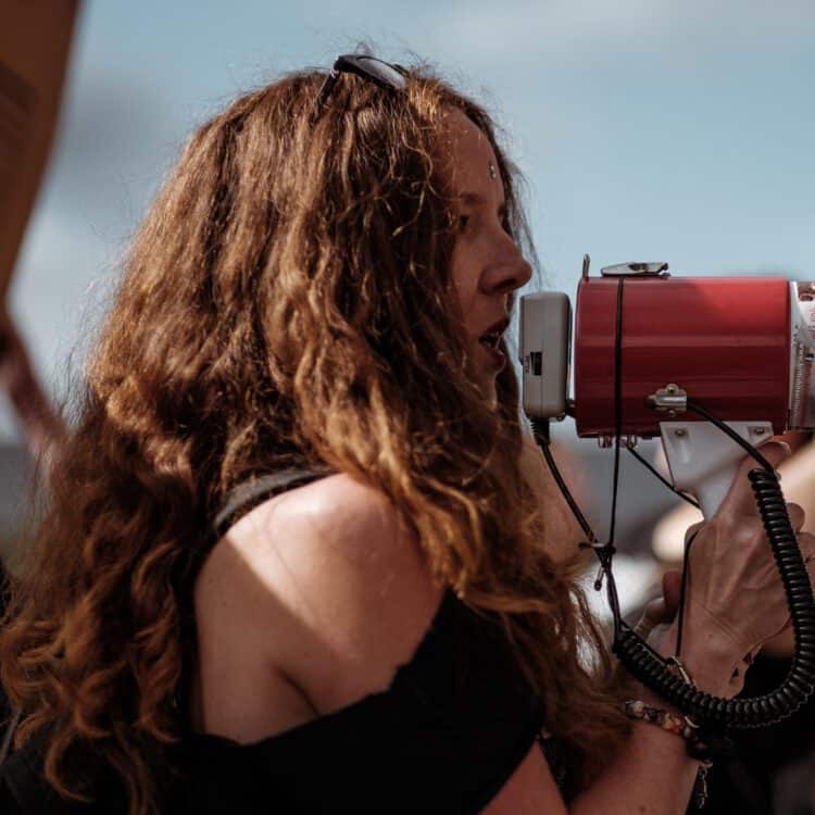 A woman speaks into a megaphone