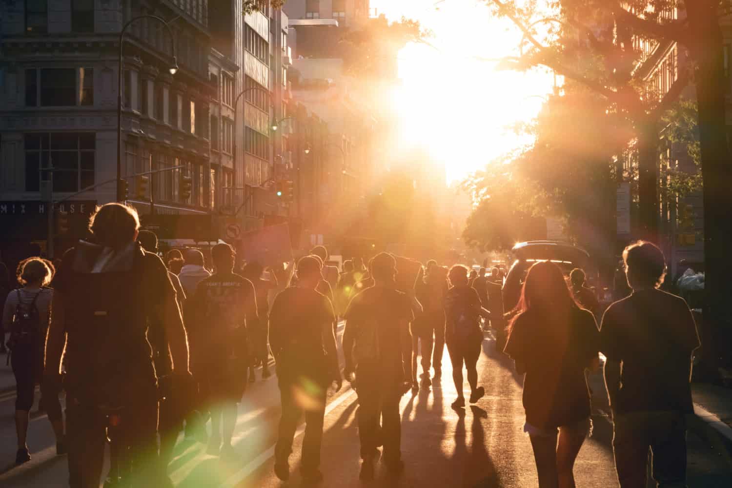 NEW YORK CITY, USA - JUNE 12, 2020: Crowd of people walk into the light of sunset at a peaceful protest march on 14th Street in Manhattan.