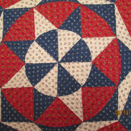 A star quilt pattern in red, white, and blue.
