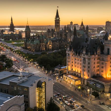 an aerial shot of ottawa, showing high rise buildings with a sunset in the background