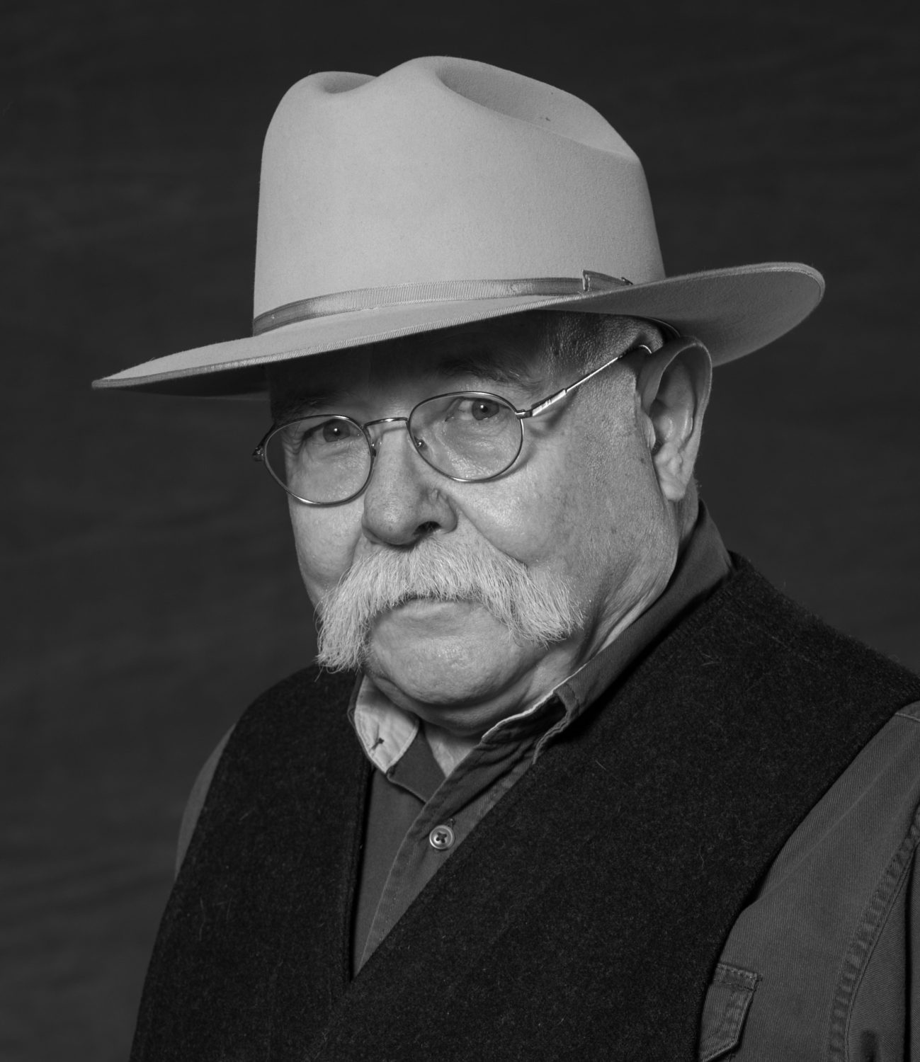 photo in hat and vest, taken at National Cowboy Poetry Gathering